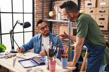 Two men artists drawing on notebook at art studio