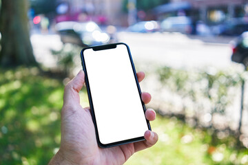 Man holding smartphone showing white blank screen at park