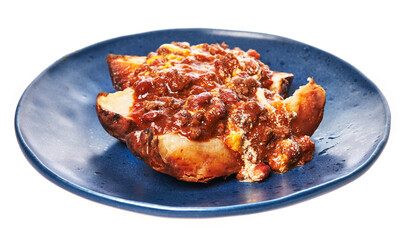 Plate of roasted potatoes with sauce over white isolated background