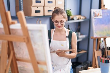 Young caucasian woman artist smiling confident drawing at art studio