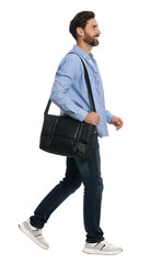 Fototapeta premium Handsome man with bag in stylish outfit walking on white background