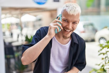 Young caucasian man smiling confident talking on smartphone at street