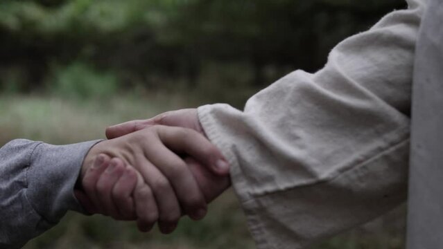 Closeup of Jesus Christ taking the hand of someone to help them