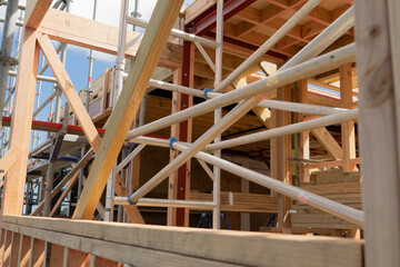 Metal scaffolding and wood building construction, building site