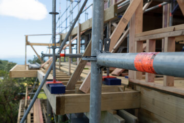 Metal scaffolding and wood building construction, building site