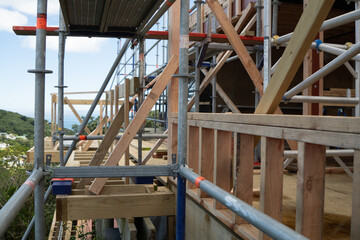 Metal scaffolding and wood building construction, building site