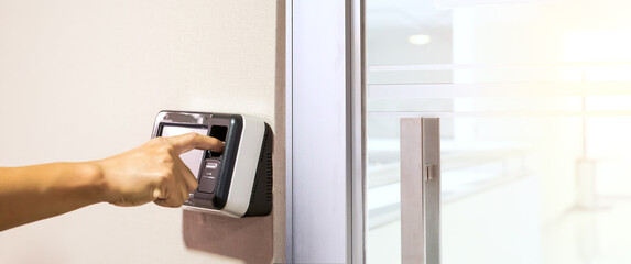Proximity card door unlock, Hand security man using fingerprint scan on ID card reader access control system for identity verification to open the door or for security safety or check attendance.