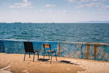 Two old chairs by the sea. 