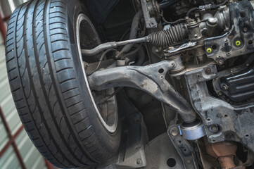 Close-up of car front suspension system components. - obrazy, fototapety, plakaty