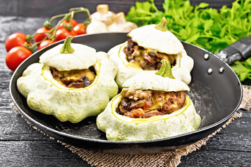 Patissons stuffed with liver in pan on board