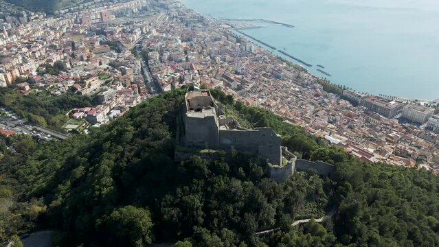 Aerial view of Arechi Castle on mountain top with Salerno downtown in background, Salerno, Campania, Italy.