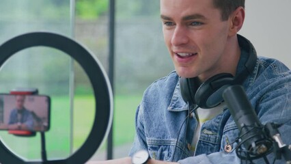 Male vlogger live streaming product review of watch recorded on mobile phone - shot in slow motion