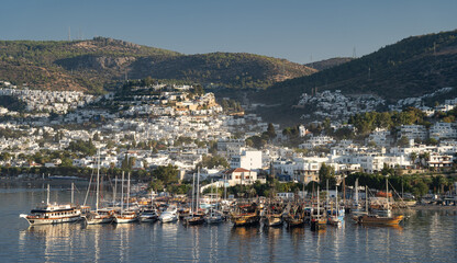 Fototapeta na wymiar Aerial view of Bodrum bay, Turkey. Seashore, sailboats, boats, mountains and fort in Bodrum. 