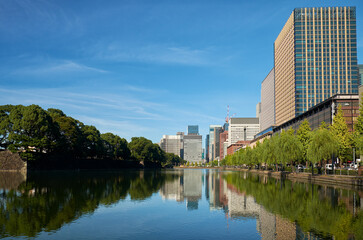 Skyscrapers of Marunouchi district reflecting in the water of Edo castle outer moat. Tokyo. Japan