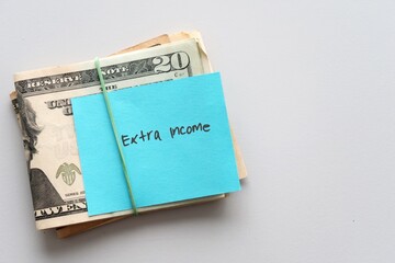 Dollars cash money and paper note with text written SIDE HUSTLE on copy space background - concept...
