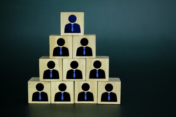 wooden cube and worker icon with hierarchical system. Business personnel management. Command and...