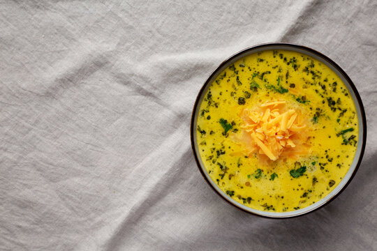 Homemade Broccoli and Cheddar Soup in a Bowl, top view. Flat lay, overhead, from above. Copy space.