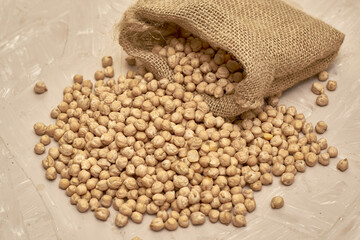 chickpeas in a canvas bag and scattered on the table
