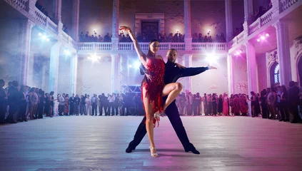 Poster Couple dancers perform latin dance on large professional stage. Ballroom dancing. © VIAR PRO studio