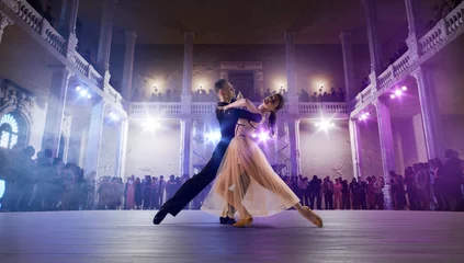 Fotobehang Couple dancers perform waltz on large professional stage. Ballroom dancing. © Artur Didyk