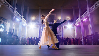 Couple dancers perform waltz on large professional stage. Ballroom dancing.