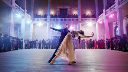 Couple dancers perform waltz on large professional stage. Ballroom dancing.