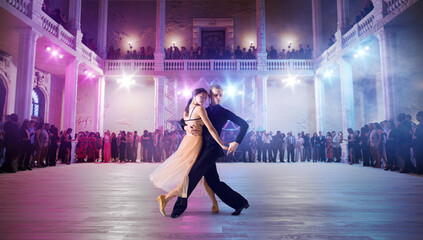 Couple dancers perform waltz on large professional stage. Ballroom dancing.