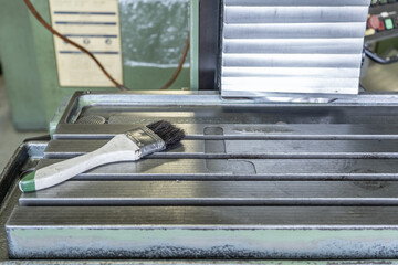 Cleaning brush on cnc machine table workshop
