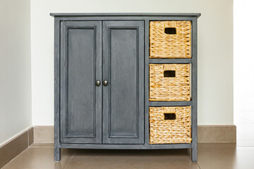 Gray wooden and wicker chest of drawer
