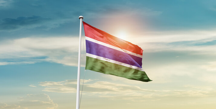 The Gambia National Flag Cloth Fabric Waving On The Sky - Image