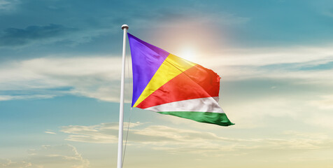 Seychelles national flag cloth fabric waving on the sky - Image