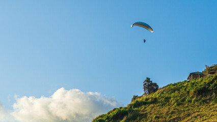 Fototapeta na wymiar Paragliding concept, paraglider pilot fly in sky on beauty nature mountain landscape.