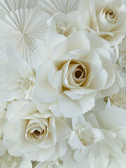big white paper roses in a group shot under the warm light, used for the background