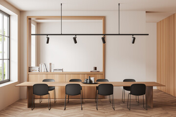 Stylish eating room interior with table and chairs, drawer with decor and window