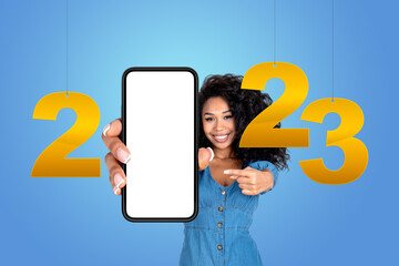 Smiling african woman finger point at phone with mockup display,