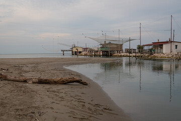View of fishing huts on shores of estuary near Comacchio valley,  Ravenna,Italy