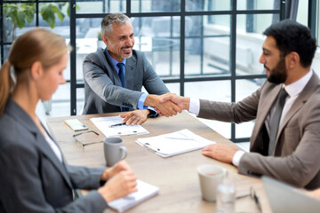 Business people shaking hands, finishing up a meeting.