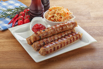 Grilled sausages with cabbage and sauce