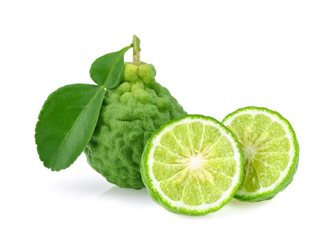 Fresh bergamot or kaffir lime fruit with cut in half slice and green leaf isolated on white background.
