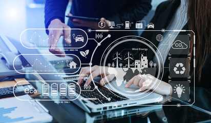 Business team working virtual modern smartphone to reduce CO2 emissions carbon footprint climate change to limit global warming.Sustainable development and green business concept.