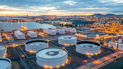 Aerial view oil terminal industrial facility storage tank oil and petrochemical product for transport storage facility, Storage tank petroleum petrochemical refinery product at oil terminal at nihgt. - obrazy, fototapety, plakaty