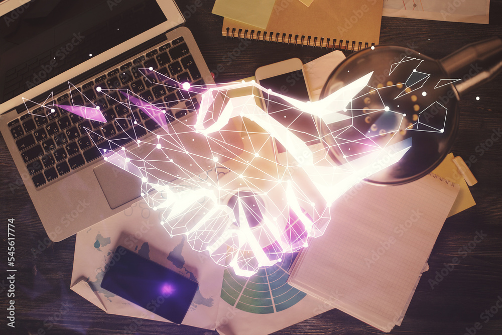 Poster handshake drawing over computer on the desktop background. top view. double exposure. partnership co