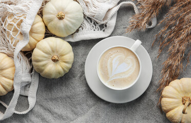 Autumn composition. Cozy home atmosphere. White pumpkins, coffee