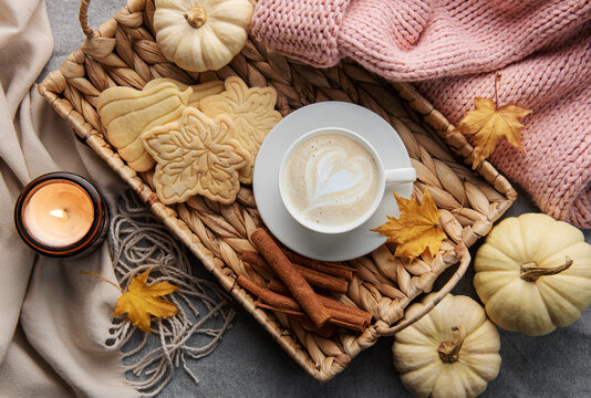 White pumpkins, coffee and autumn leaves
