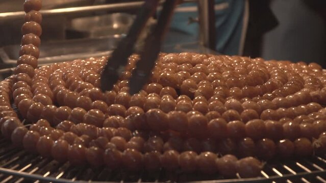 Thai isaan sausage cooking, close up.