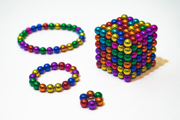 Magnetic constructor made of multicolored balls on a white background. A cube of magnetic balls....