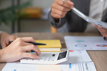 Marketing, Finance, Accounting, Planning, Team of business use calculators and graph analysis computer laptop tablets to plan marketing strategies and make profitable investments for the company.