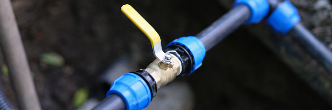 Water valve connected to PVC pipe closeup