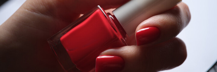 Stylish bright red lacquer on female nails concept