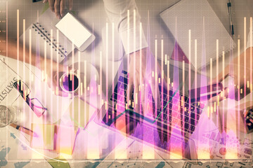 Double exposure of man and woman working together and forex graph hologram drawing. Financial analysis concept. Computer background. Top View.